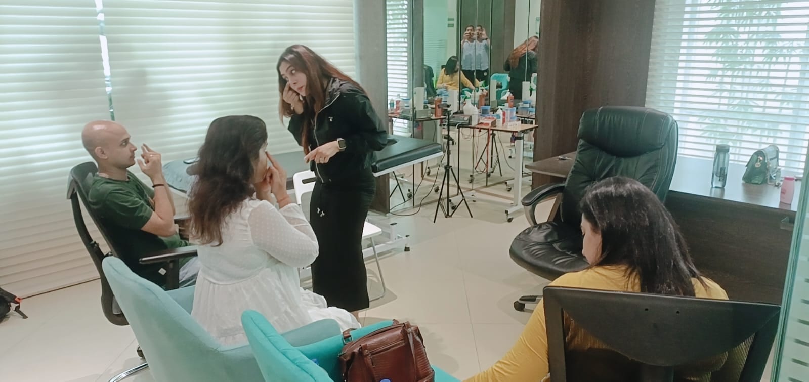 Vibha Jain explaining an exercise to a small group seated in a bright consulting room.