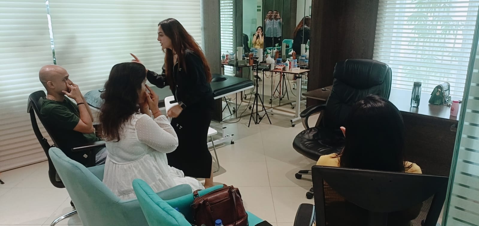 Vibha Jain in conversation with participants in a bright consulting room, explaining an approach.